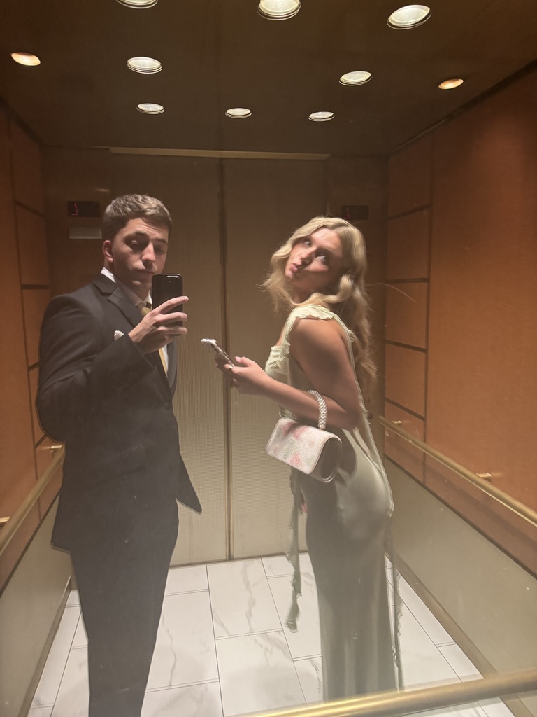 Macie and Kenny dressed up in an elevator mirror selfie