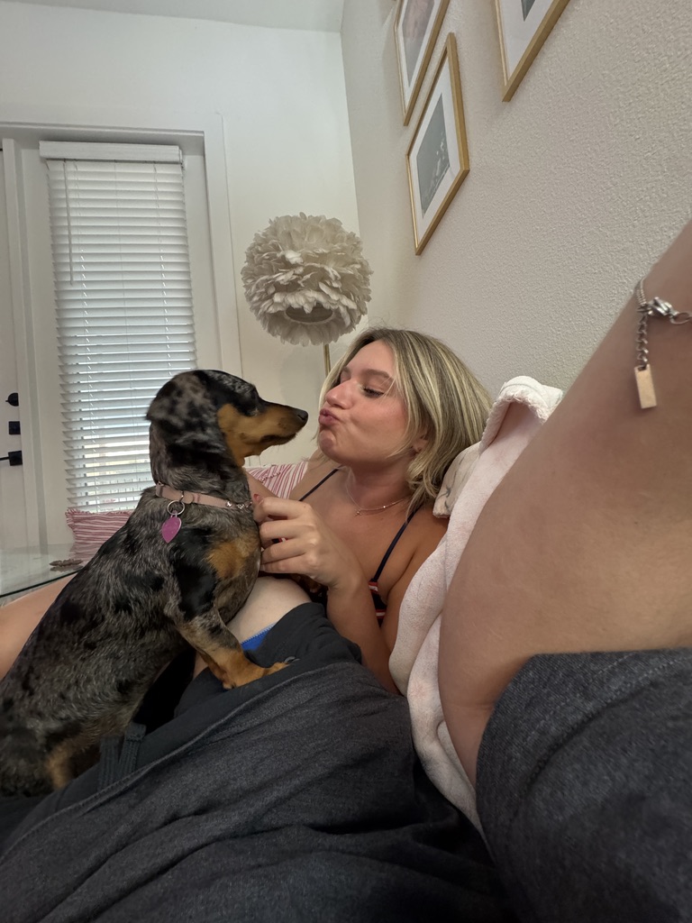 Macie giving Coco a kissy face in bed