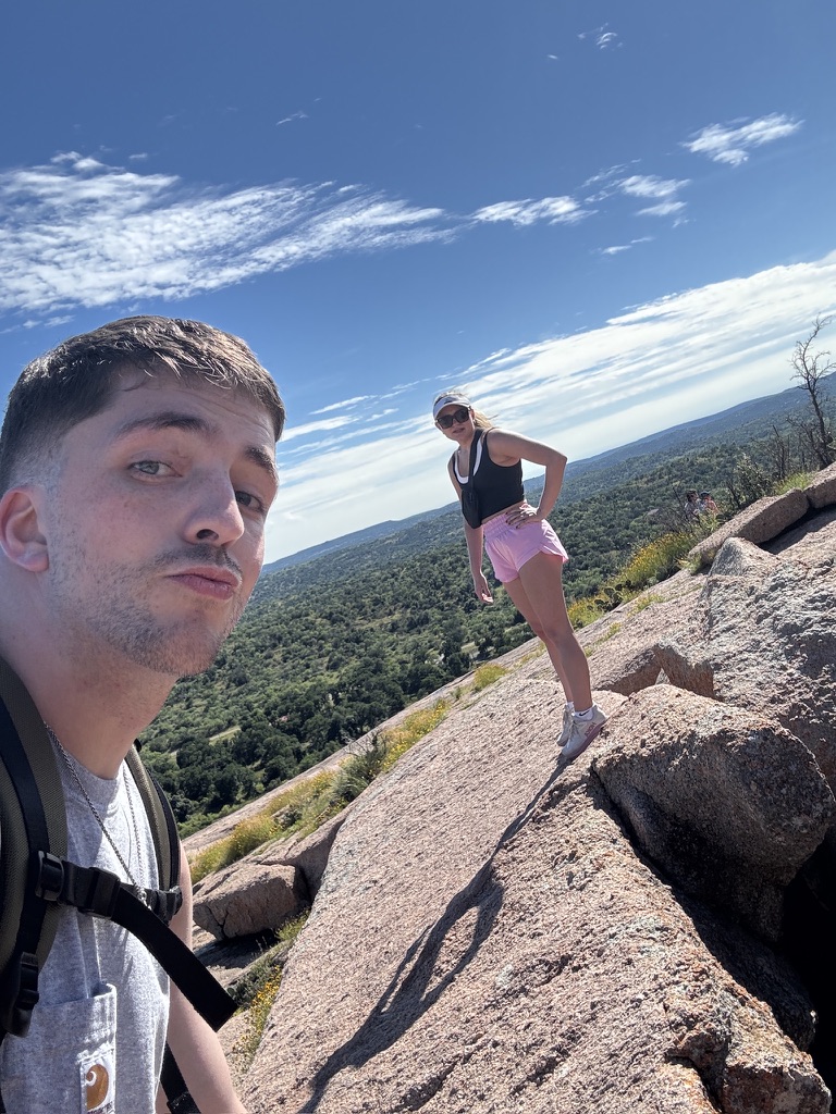 Macie and Kenny hiking on a big granite rock