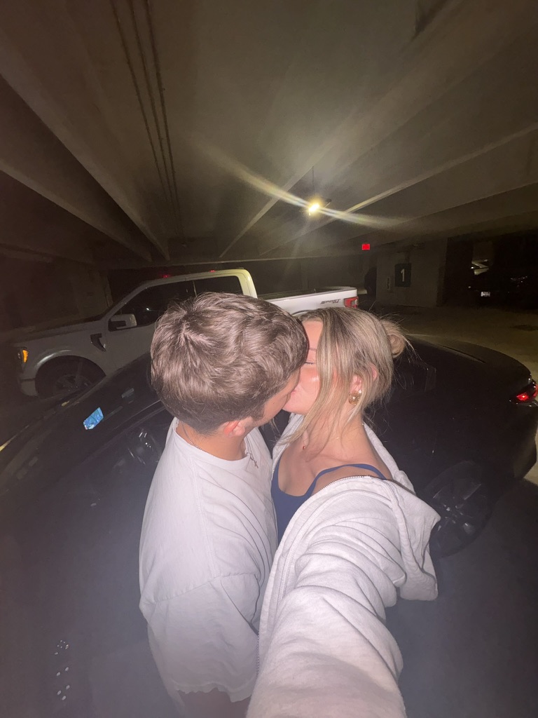 Macie and Kenny kissing in a parking garage