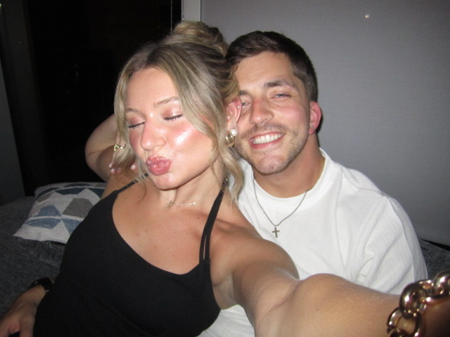 Macie making a kissy face while Kenny smiles